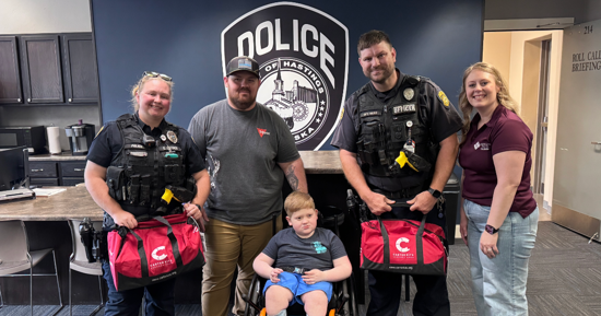 Members of the Hastings Police and Kelley Family pose with their new Carter Kits. Photo Courtesy:Hastings Police Department